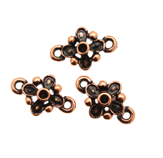 Distanziatore a forma di fiore con quattro petali e quattro palline, con due anelli, 12x17 mm.